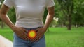 Menstrual pain disturbing woman walking in park, polycystic ovary syndrome