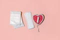 Menstrual tampon medical pad on pink background, top view, hard shadow, copyspace. Concept of choosing between protection