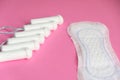 Menstrual tampons and pads isolated on pink background