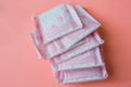 Menstruation, Wrapped pink period pads against pink background Royalty Free Stock Photo