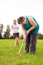 Mental disabled woman is playing crocket to train her motor abilities Royalty Free Stock Photo