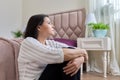 Sad, frustrated, depressed mature woman sitting at home on the floor Royalty Free Stock Photo