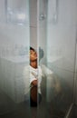 Mental health, anxiety and depression by sad woman sitting on floor the of a shower, stress and afraid. Young female Royalty Free Stock Photo