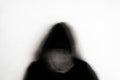 A mental health concept. Of a blurred abstract hooded figure against a white background. With a grunge, textured edit