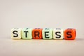 Alphabet letter dice text on desk, spelling STRESS