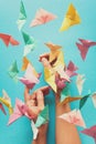 Mental health concept. Colorful paper butterflies flying and sitting on woman`s hands. Harmony emotion.