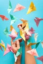 Mental health concept. Colorful paper butterflies flying and sitting on woman`s hands. Harmony emotion. Origami. Paper cut style