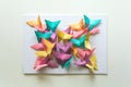 Mental health concept. Colorful paper butterflies sitting on book in shape of butterfly. Harmony emotion. Origami. Paper cut style