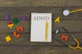 Mental health concept - text ADHD, attention deficit hyperactivity disorder, notepad, stethoscope, colorful jigsaw puzzle