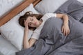 Mental health disorders. Top view of unhappy woman lying in bed, suffering from depression, anxiety or insomnia Royalty Free Stock Photo