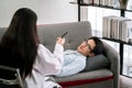 Mental Health: Female doctor writing clipboard while check up body a middle-aged patient Royalty Free Stock Photo