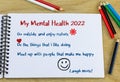 Mental health goals 2022 heading with list of ideas hand written in note book on desk Royalty Free Stock Photo