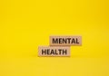 Mental Health symbol. Concept word Mental Health on wooden blocks. Beautiful yellow background. Psychology and Mental Health Royalty Free Stock Photo