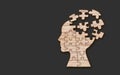 Mental health symbol. Human head silhouette with a puzzle cut out from wooden background Royalty Free Stock Photo
