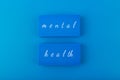 Mental health text written on blue blocks on blue background Royalty Free Stock Photo