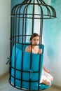 Mental mind. prisoner woman in cage - home confinement. freedom of cute girl in cage chair. fashion slave in captivity