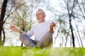 Pleasant aged man practicing yoga