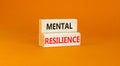 Mental resilience symbol. Concept word Mental resilience typed on wooden blocks. Beautiful orange table orange background.