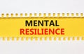 Mental resilience symbol. Concept word Mental resilience typed on yellow and white paper. Beautiful yellow and white background.