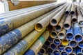 Mental scaffold pipe stack together on scaffold plank wood shelve with blue, green and yellow mark at the tip for build the tempo