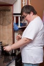 Mentally disabled woman is cooking Royalty Free Stock Photo