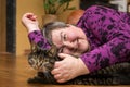 Mentally disabled woman cuddling a cat, animal assisted therapy