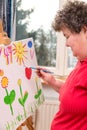 Mentally disabled woman painting a picture Royalty Free Stock Photo