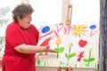 Mentally disabled woman showing her painting Royalty Free Stock Photo