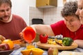 Mentally disabled woman and two caretakers cooking together