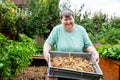 Mentally handicapped woman holding a basket full of fresh onions