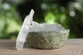 Menthol crystals on wooden table against blurred background