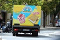 Italian Ice Cream Truck Driving on The Road in The City Center