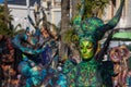 Menton, France-February 12, 2023: Close up woman dressed colorful green fantastic carnival costume