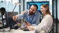 Mentor teaching young employee to troubleshoot software errors using AI Royalty Free Stock Photo
