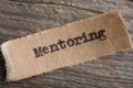 mentoring word on a piece of paper close up, business creative motivation concept