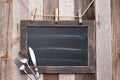 Menu blackboard with fork, spoon and knife on wood background Royalty Free Stock Photo