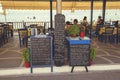 Menu board in front of beach restaurant 4