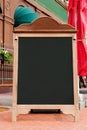 Menu board on street near cafe or restaurant with no text on it. Royalty Free Stock Photo