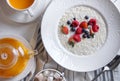 Menu at the cafe, Breakfast, Porridge with berries, Bulgur with coconut milk. Flatlay, Top view, Moody on black background,