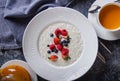 Menu at the cafe, Breakfast, Porridge with berries, Bulgur with coconut milk. Flatlay, Top view, Moody on black background,