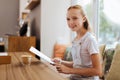 Smiling teenager holding menu in her hands