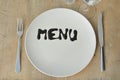 Menu inscription on a plate. Set table. Cutlery. Glasses. Suitable as a background. Royalty Free Stock Photo