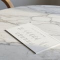 A menu mockup rests on a light-colored marble table. The menu appears to be a Royalty Free Stock Photo