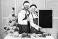 Menu for our family. Man and woman chef santa hat near christmas tree hold blackboard copy space. Couple check list