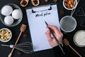 MENU PLAN Baking cooking Ingredients on black background. Top view. Blank clipboard copy space. Home baking: cookies, bread, cake Royalty Free Stock Photo