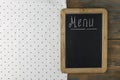 Menu title written with chalk on blackboard lying on tablecloth polka dot. Copy space for your text. Top view