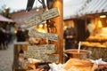 Menu written in different languages on wooden plates on the most authentic Christmas market in Riga offering dozens of crafts and