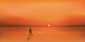 Sunset on the ocean with a lonely man who dreams while walking on the beach Royalty Free Stock Photo