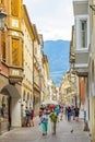 Street scenario of Laubengasse in the main District of Meran with many pedestrians. Merano. South Tyrol, Italy