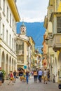 Street scenario of Laubengasse in the main District of Meran with many pedestrians. Merano. South Tyrol, Italy